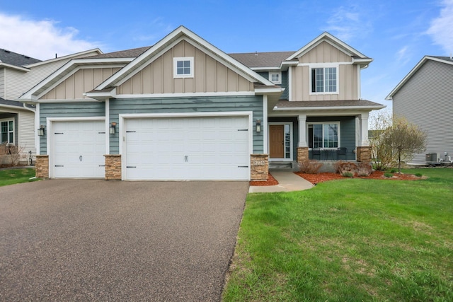 craftsman-style house with an attached garage, board and batten siding, driveway, and stone siding