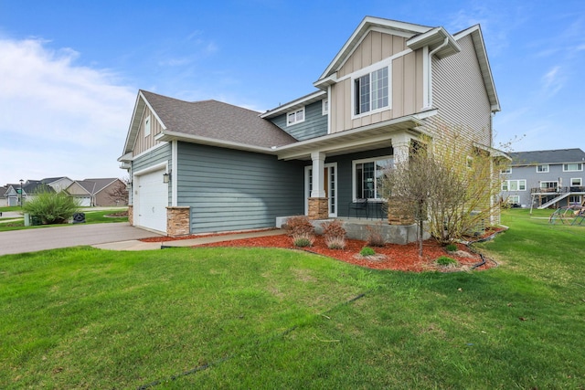 craftsman house featuring a garage, a front yard, board and batten siding, a porch, and driveway