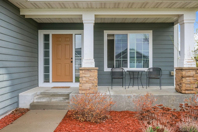 view of exterior entry with covered porch