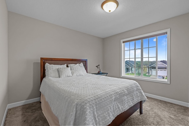 bedroom featuring baseboards and carpet floors