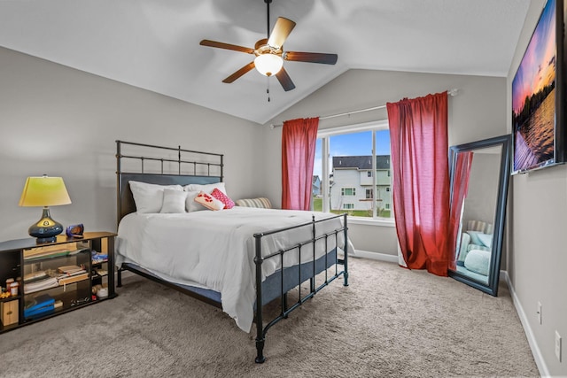carpeted bedroom with ceiling fan, vaulted ceiling, and baseboards