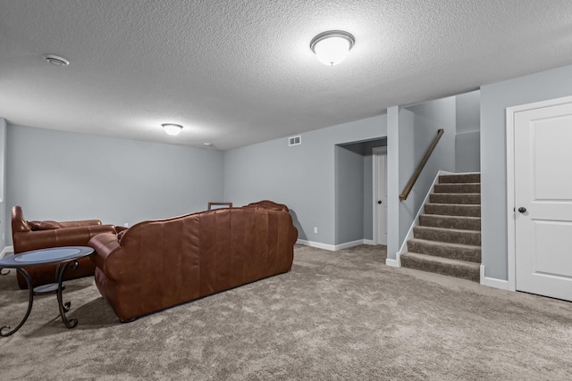 living room featuring carpet, stairs, a textured ceiling, and visible vents