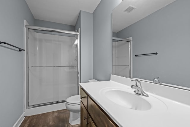 full bath with wood finished floors, toilet, and a shower stall