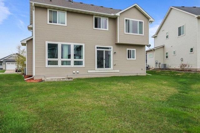 back of property featuring a lawn and cooling unit
