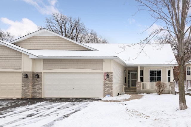 ranch-style home featuring a garage, brick siding, and a porch