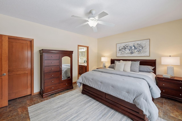 bedroom with connected bathroom, stone finish flooring, a textured ceiling, and a ceiling fan