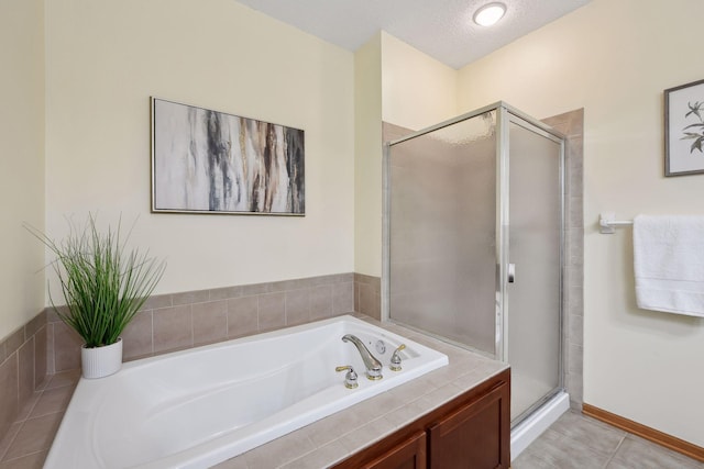 full bath with a textured ceiling, tile patterned flooring, a shower stall, and a garden tub