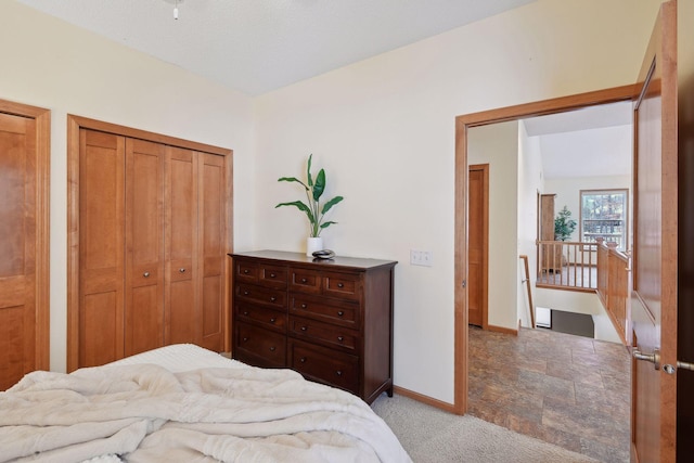 bedroom with lofted ceiling, baseboards, and light colored carpet