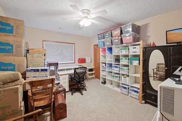 office space featuring a textured ceiling, carpet floors, and ceiling fan