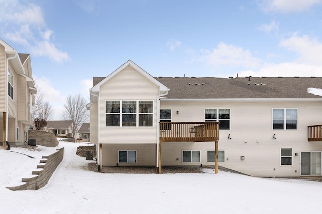 snow covered property with a wooden deck