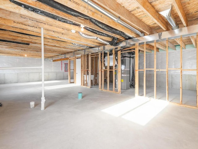 basement featuring heating unit and electric panel