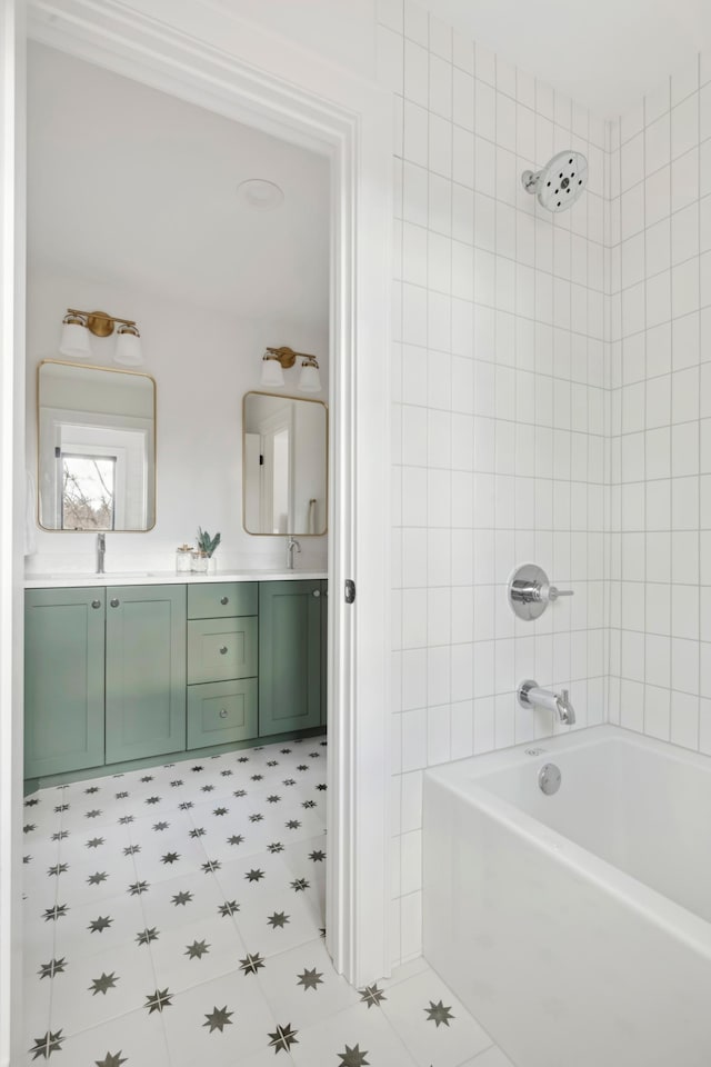 bathroom with vanity and tiled shower / bath combo