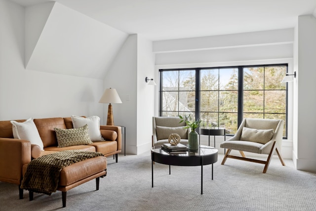 living room featuring light carpet and lofted ceiling