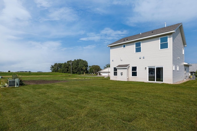 back of property featuring a lawn