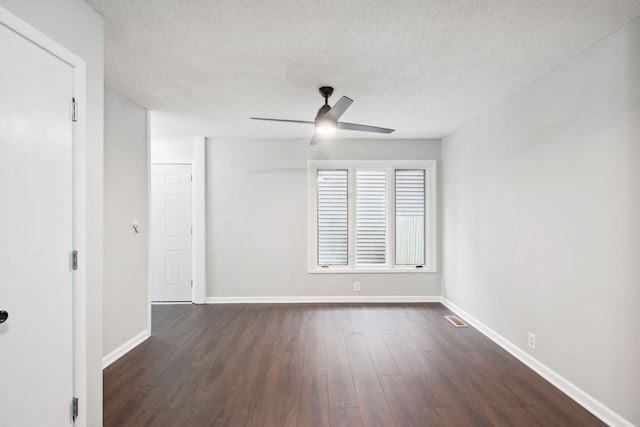 spare room featuring a textured ceiling, dark hardwood / wood-style flooring, and ceiling fan