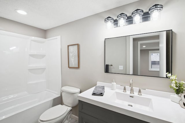 full bathroom featuring washtub / shower combination, a textured ceiling, vanity, and toilet