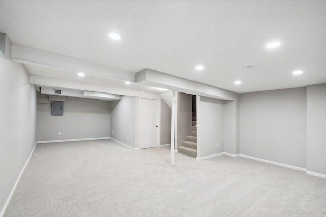 basement featuring electric panel and light carpet