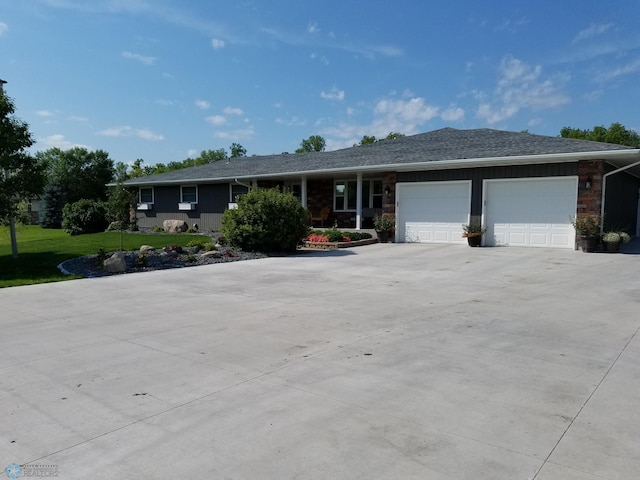 single story home featuring a garage and a front lawn