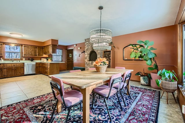 dining area with light tile patterned floors and a notable chandelier