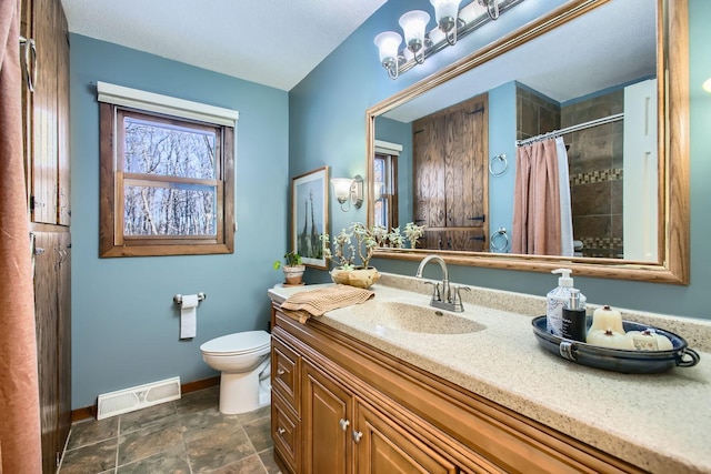 bathroom featuring visible vents, toilet, vanity, a shower with curtain, and baseboards