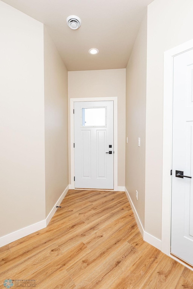 doorway to outside with light wood-type flooring