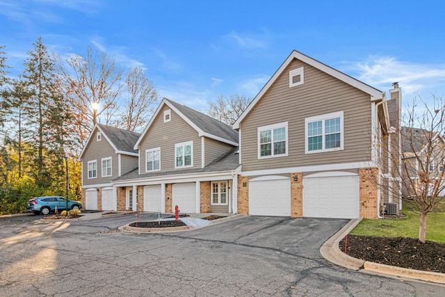 front of property featuring a garage and central AC unit