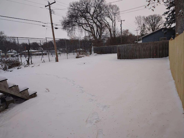 view of yard layered in snow