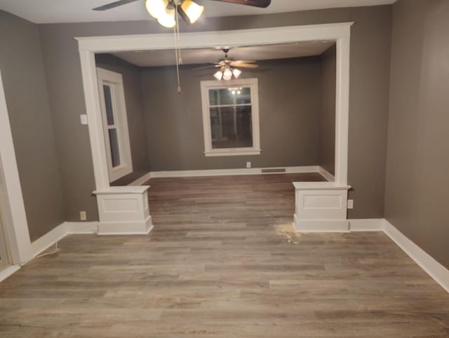 spare room with ceiling fan and wood-type flooring