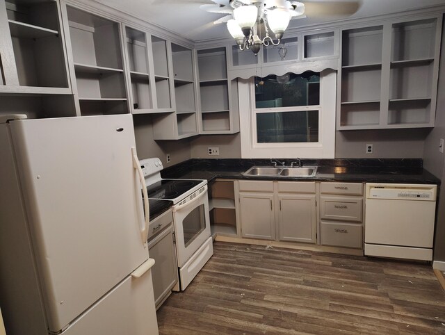 kitchen featuring white appliances, dark wood-type flooring, and sink