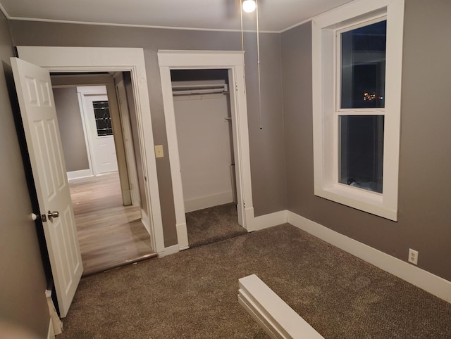 unfurnished bedroom with carpet floors and a closet