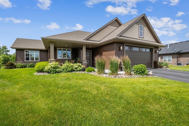 craftsman house with a garage and a front lawn