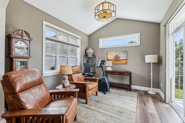 sitting room featuring hardwood / wood-style floors and lofted ceiling