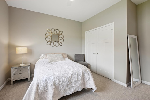 carpeted bedroom with a closet and ceiling fan