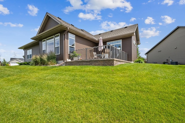 back of property featuring a lawn and cooling unit