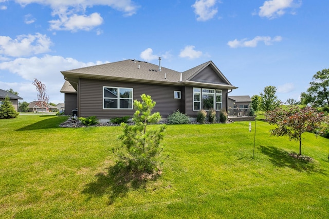 rear view of house with a yard