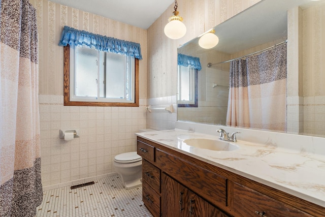 bathroom featuring tile walls, vanity, walk in shower, toilet, and tile patterned floors