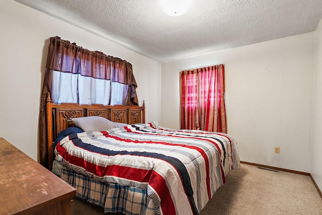 carpeted bedroom featuring a textured ceiling