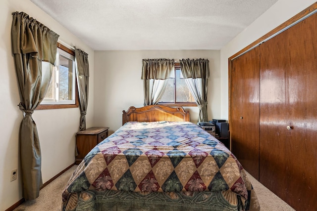 carpeted bedroom featuring multiple windows, a closet, and a textured ceiling