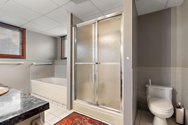 full bathroom featuring tile patterned flooring, independent shower and bath, and a drop ceiling