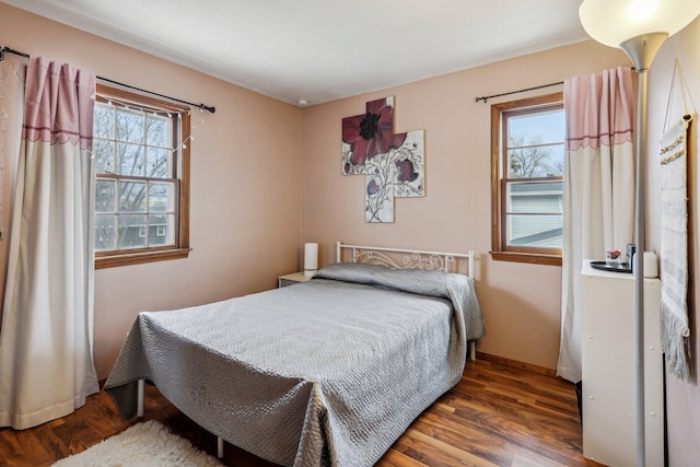 bedroom with dark hardwood / wood-style flooring