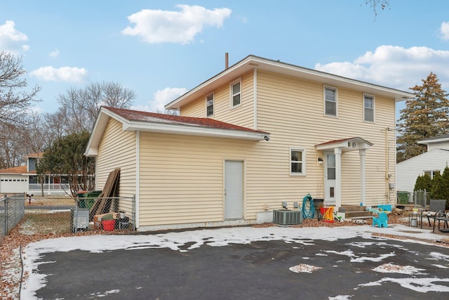 rear view of house featuring central AC