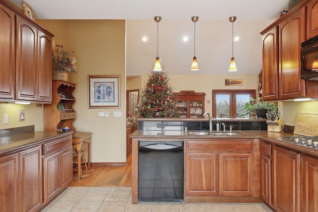 kitchen featuring sink, pendant lighting, black appliances, and light tile patterned floors