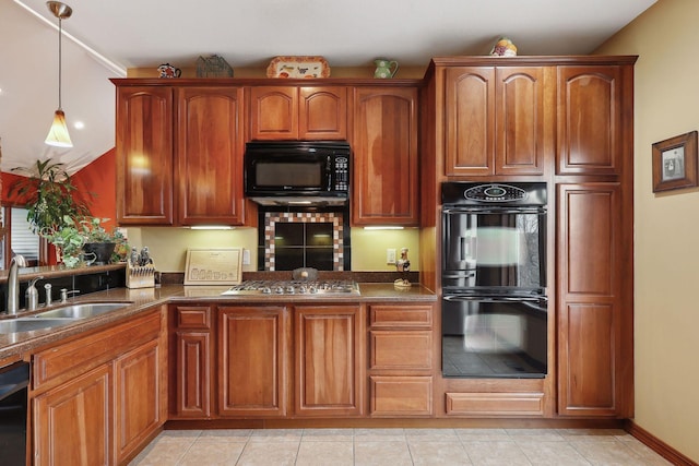 kitchen with black appliances, decorative light fixtures, sink, and light tile patterned floors