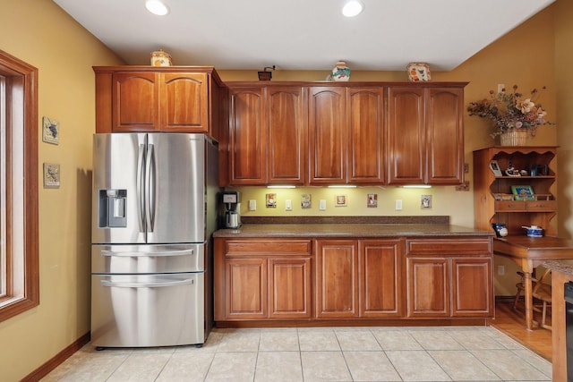 kitchen featuring stainless steel refrigerator with ice dispenser and light tile patterned floors