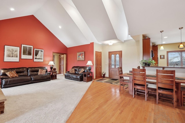 living room featuring high vaulted ceiling and light wood-type flooring