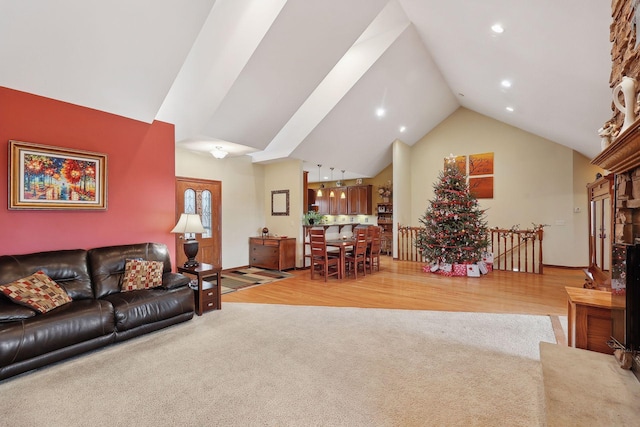 living room featuring high vaulted ceiling and hardwood / wood-style flooring