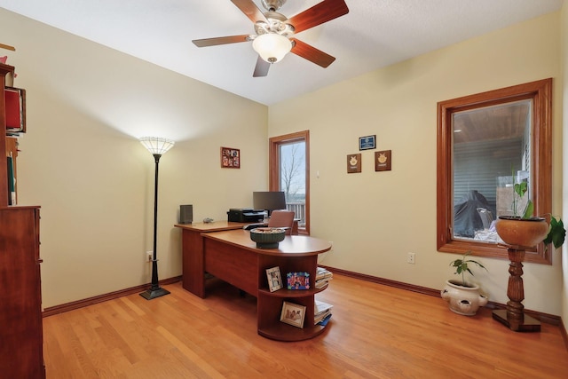 office with light hardwood / wood-style floors and ceiling fan