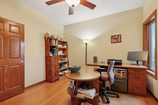 home office featuring light wood-type flooring and ceiling fan