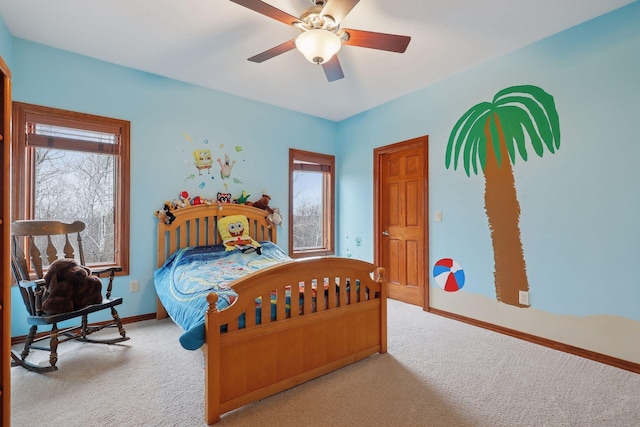 carpeted bedroom with ceiling fan and multiple windows