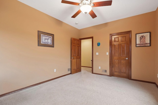 unfurnished bedroom with ceiling fan and light colored carpet